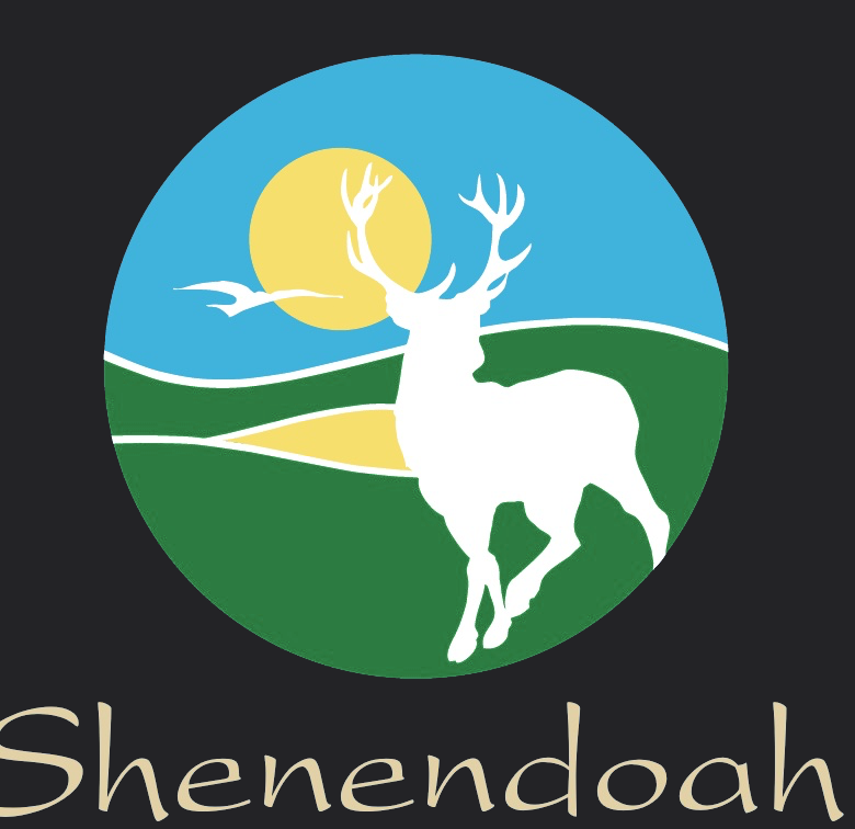 Shenendoah crest in full color, a white stag on green ground under a yellow sun and blue sky, above the name in cream script